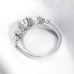 Silver ring with five round diamonds.