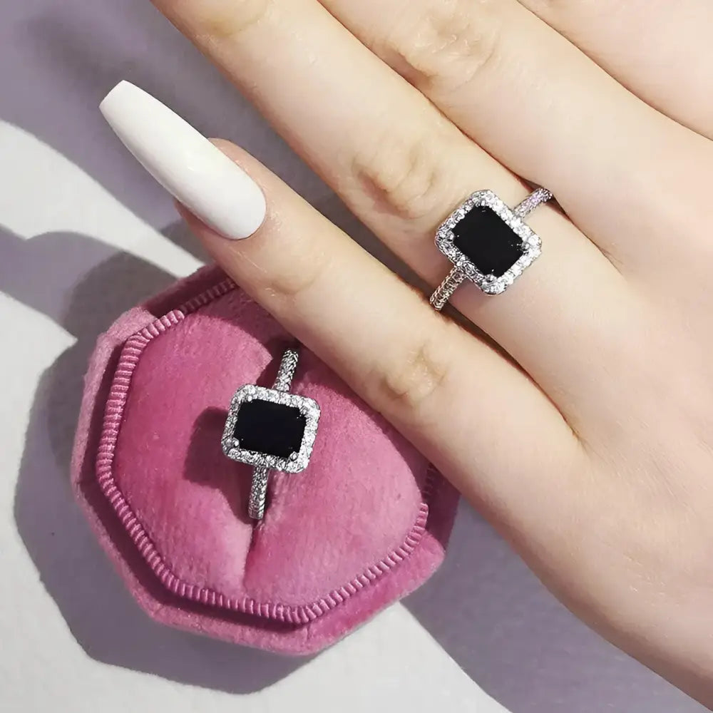 Black gemstone rings with diamond halos.