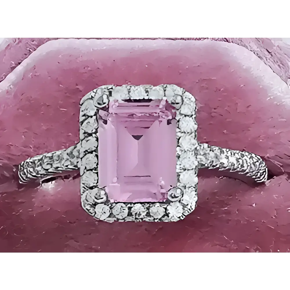 Pink gemstone ring with diamond halo.