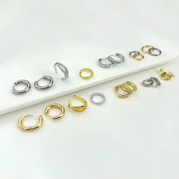 Assorted gold and silver hoop earrings.