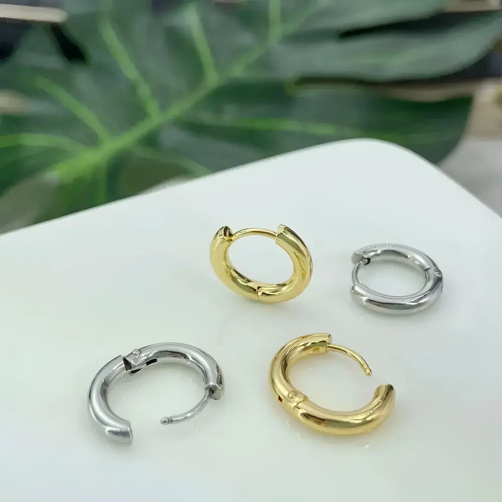 Four hoop earrings, two gold and two silver.
