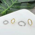 Four metal hoop earrings.