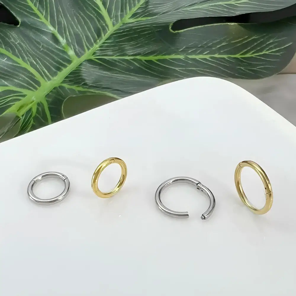 Four metal hoop earrings.