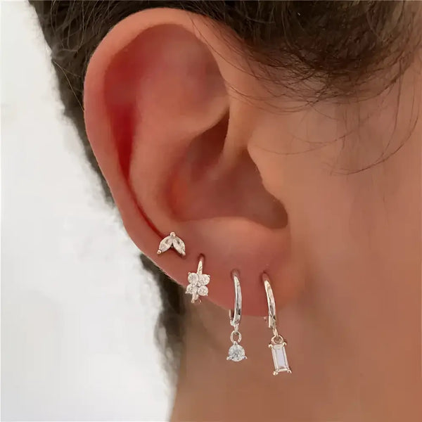 Ear with multiple earrings.