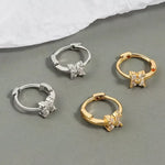Four hoop earrings with floral accents.