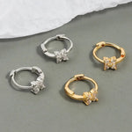 Four hoop earrings with floral accents.
