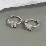 Silver hoop earrings with floral accents.