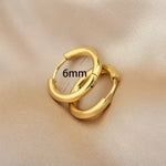 Pair of gold hoop earrings.