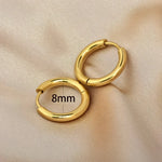 Pair of gold hoop earrings.