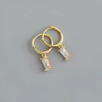 Gold hoop earrings with rectangular crystals.