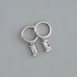 Silver hoop earrings with rectangular crystal pendants.