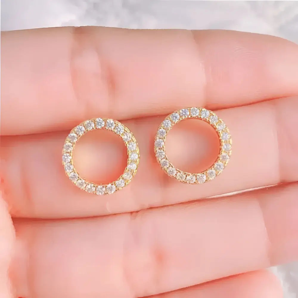Circular gold and diamond earrings.
