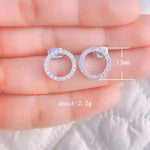 Circular diamond stud earrings.