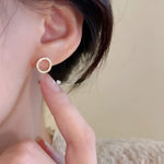 Circular stud earring with gemstones.