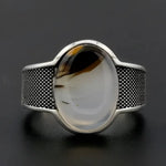 Silver ring with oval stone.