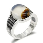 Silver ring with oval stone.