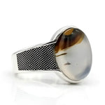 Silver ring with oval stone.