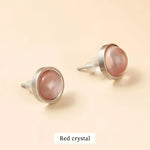 Pair of red crystal stud earrings.