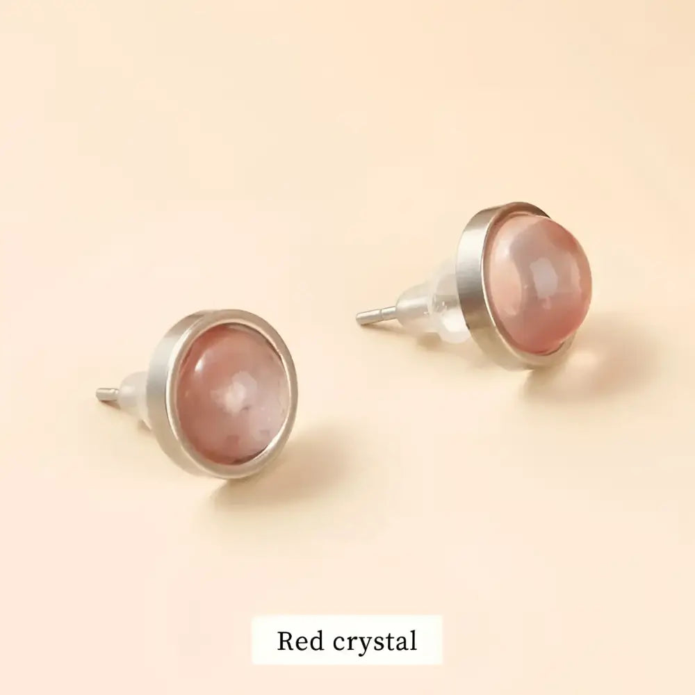Pair of red crystal stud earrings.