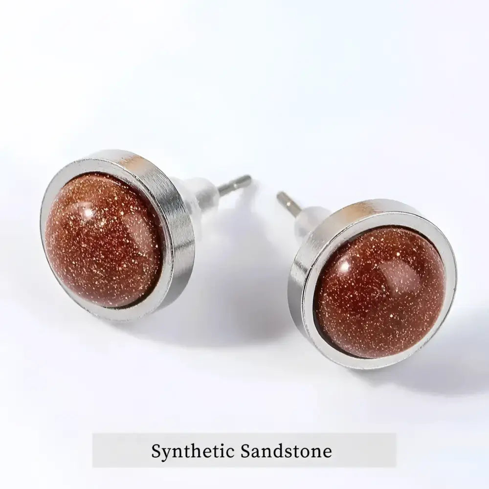 Pair of round, brown, glittery stud earrings.