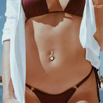 Woman’s navel piercing.