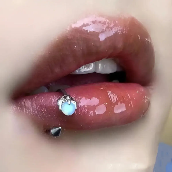 Glossy lips with piercings.
