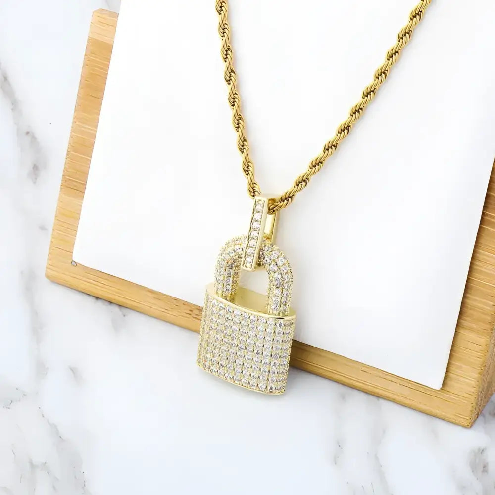 Gold chain with jeweled padlock pendant.