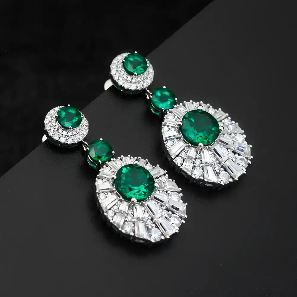 Emerald and diamond drop earrings.