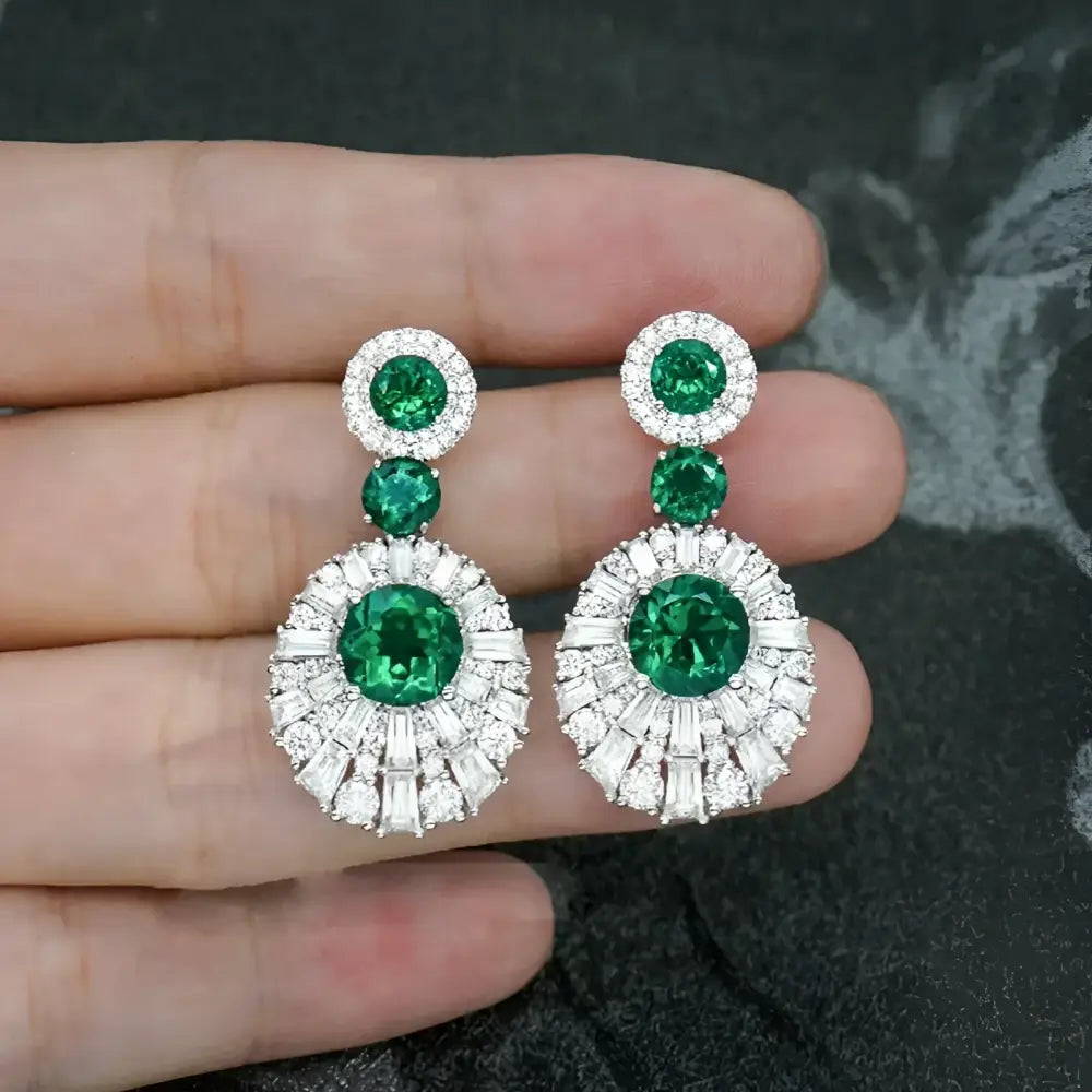 Emerald and diamond drop earrings.