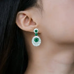 Emerald and diamond drop earrings.