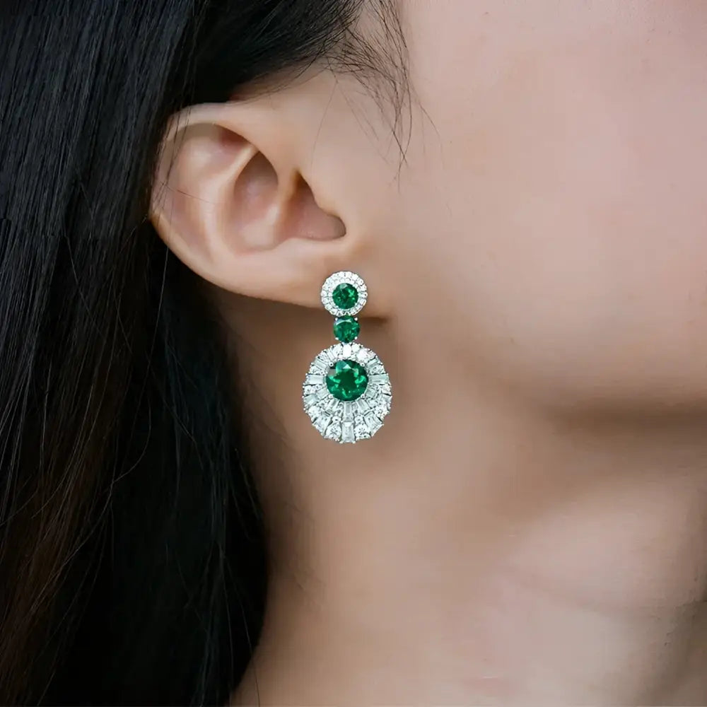 Emerald and diamond drop earrings.