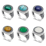 Silver rings with various gemstone cabochons.