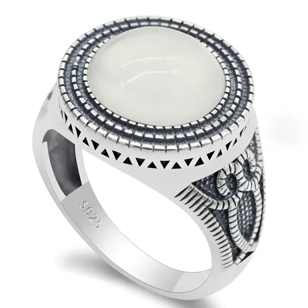 Silver ring with a white stone.
