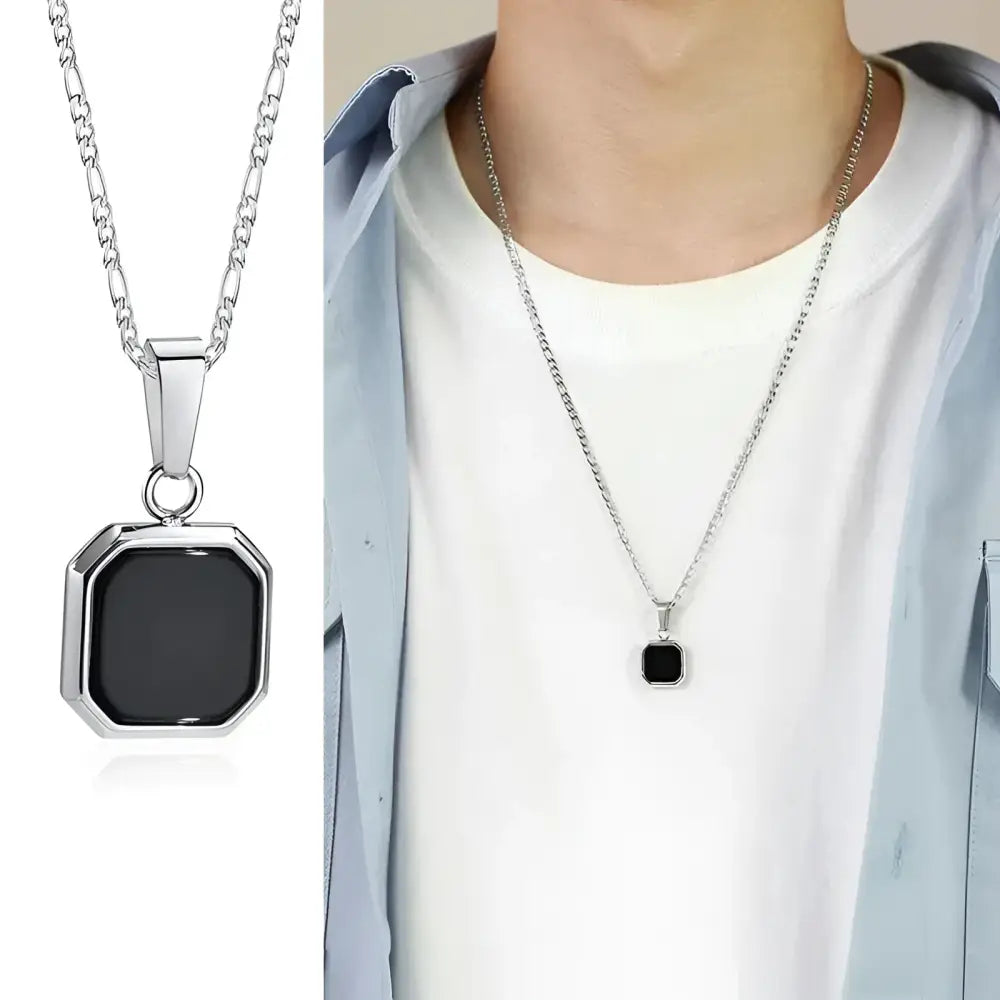 Silver necklace with black square pendant.
