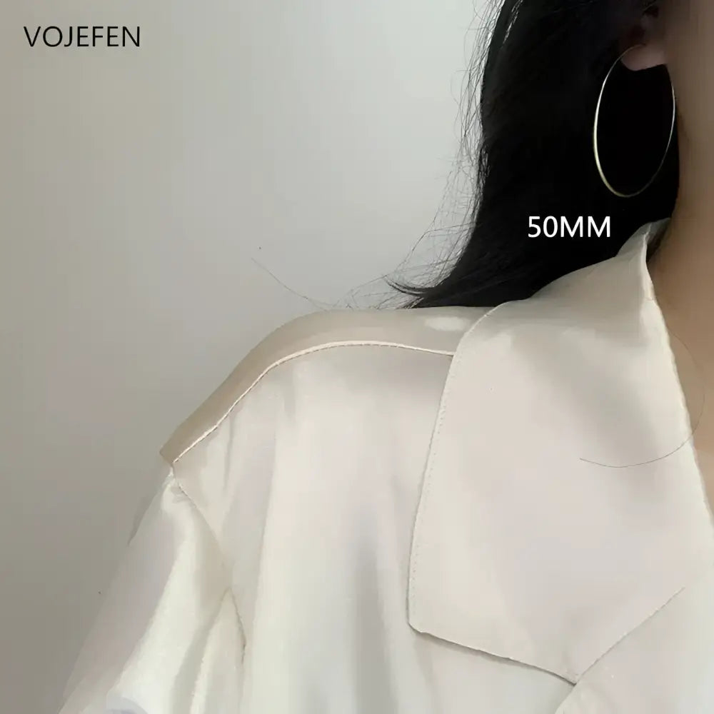 Gold hoop earring.