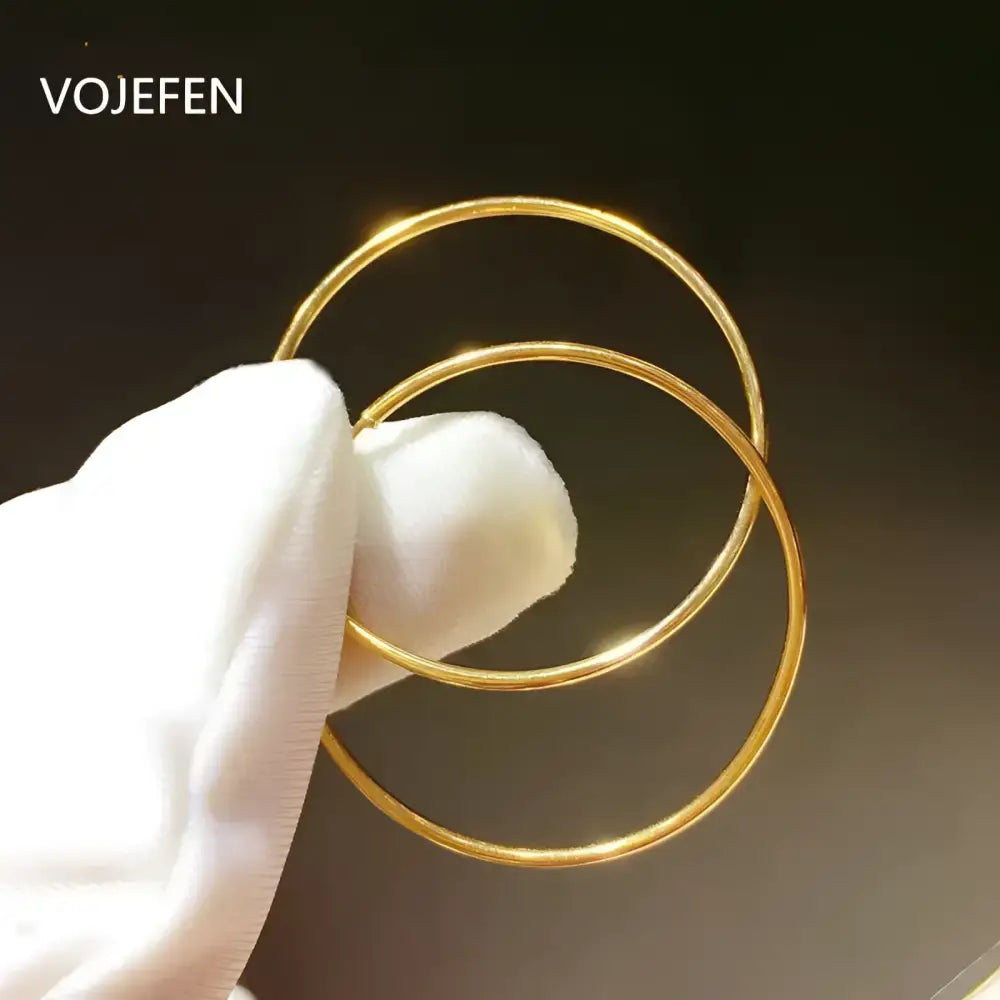 Pair of gold hoop earrings.