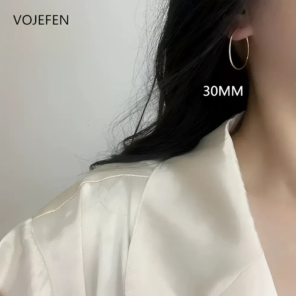 Silver hoop earring.