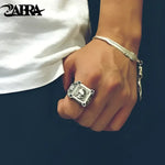 Silver skull ring and feather bracelet.