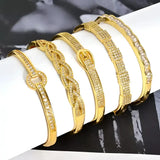 Gold-toned, jeweled bangle bracelets.