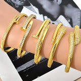 Gold-toned nail-shaped bracelets.